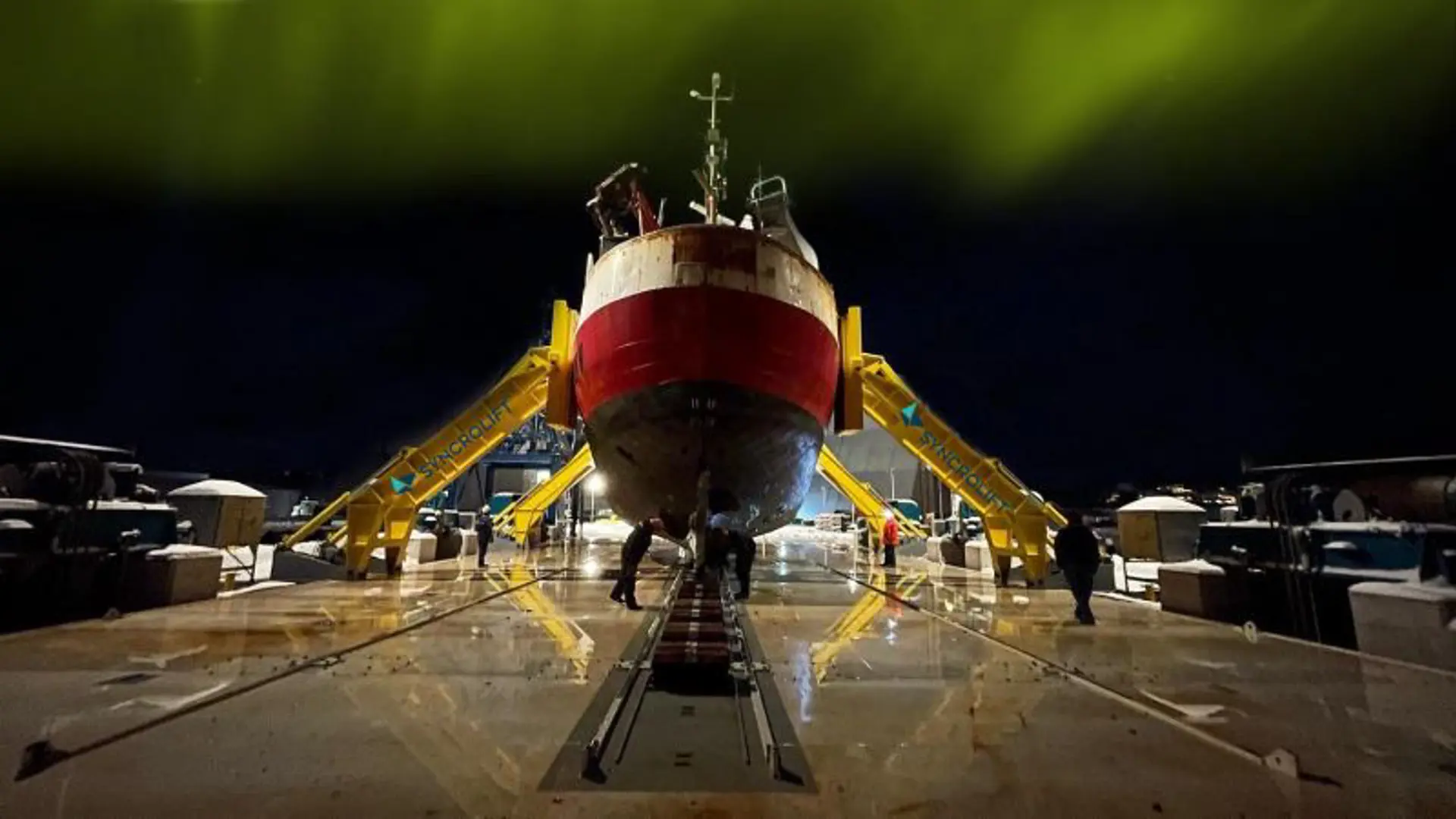 Fishing boat docked on shiplift using side support arms