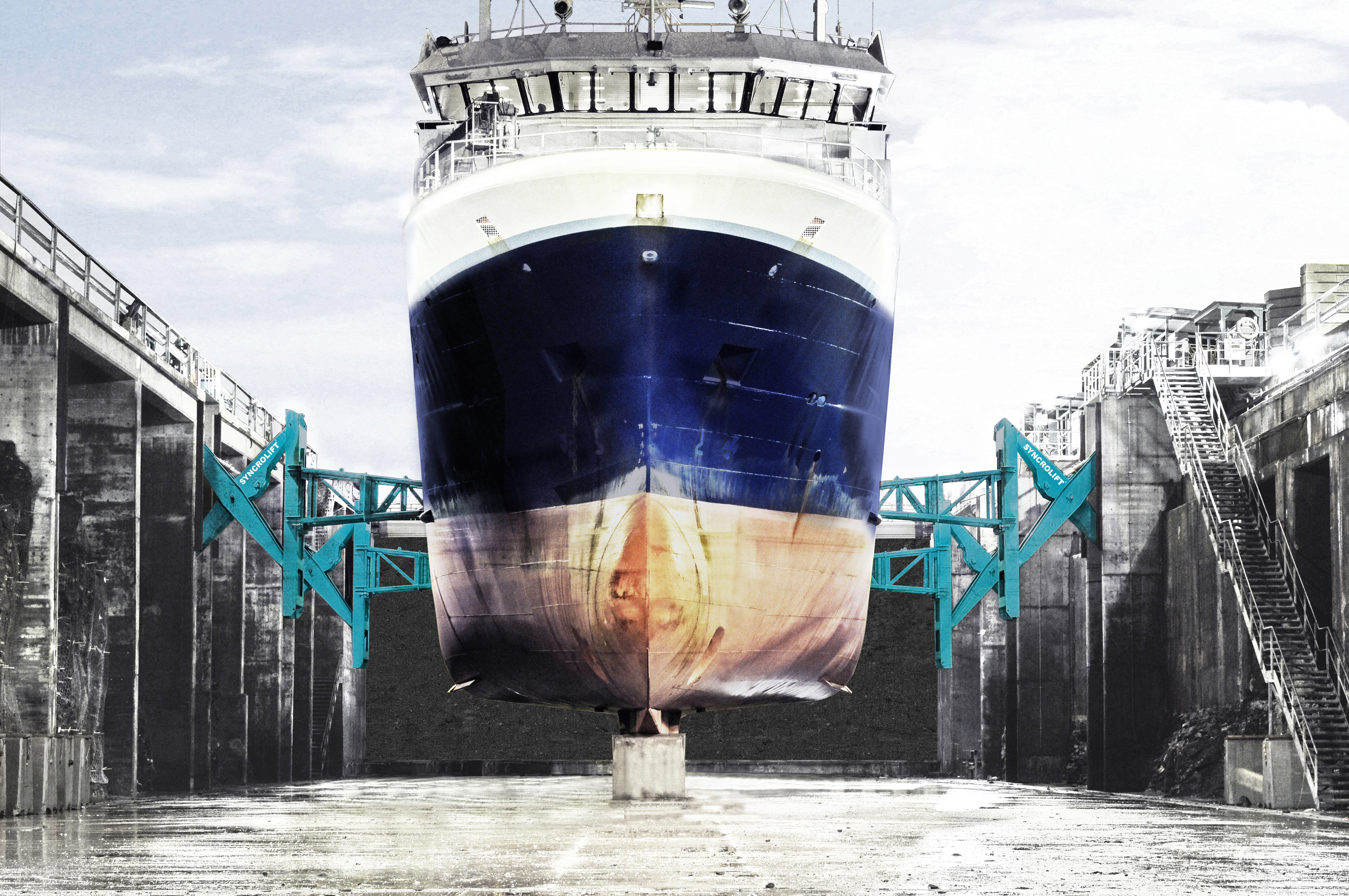 Dry dock side support arms stabilizing ship at Harstad shipyard